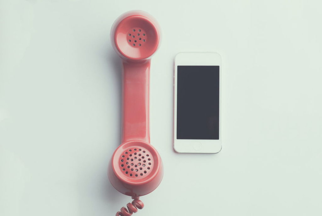 old red phone and a smartphone