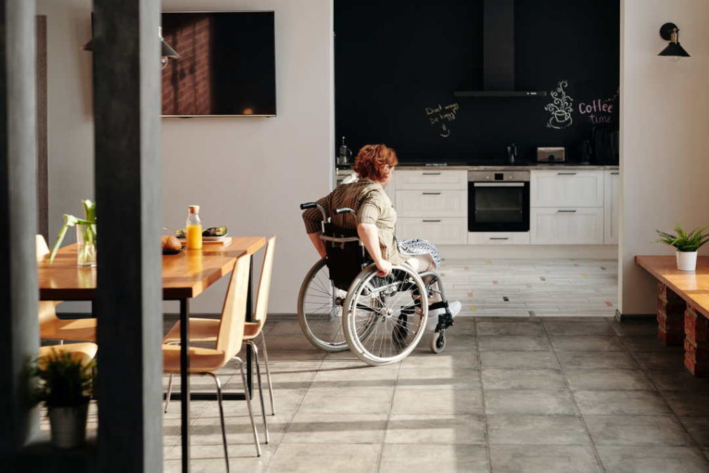 woman in a wheelchair in a company cafeteria